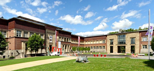  Der Ehrenhof des Kunstpalasts mit Brunnen und Übergang – vorn rechts das Bronze-„Nashorn" von Johannes Brus